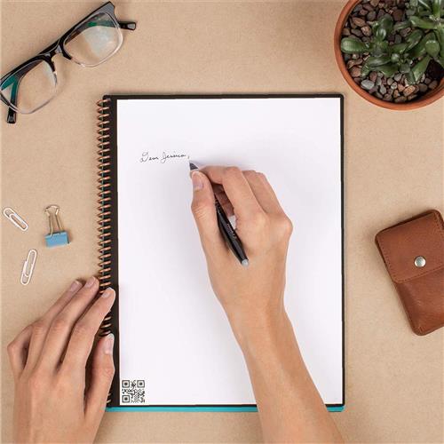 Person writing in stationery notebook